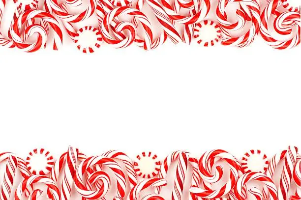 Christmas candy double border with peppermints and candy canes over a white background