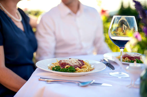 istock Romatic italian dinner outside of pasta and wine 615596698
