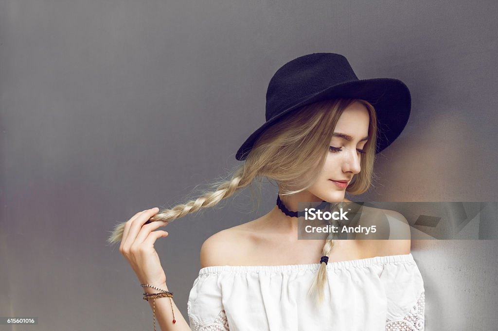 Beautiful young woman with two pigtails Close up of beautiful young  blonde woman with black hat. Her hair is tied in two big ponytails. Around neck she has black choker. Artist's Model Stock Photo