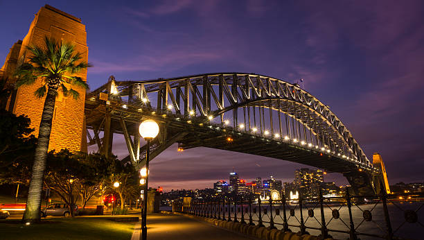 istock Sydney harbor bridge with pink clouds 615603622
