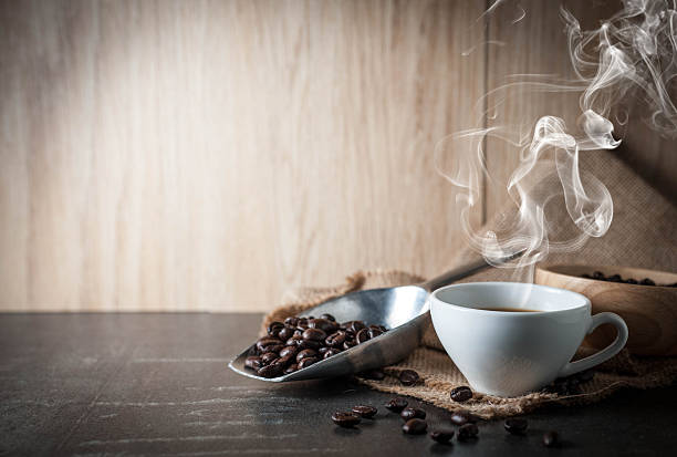 istock Coffee cup with coffee bean on black stone background 615603952