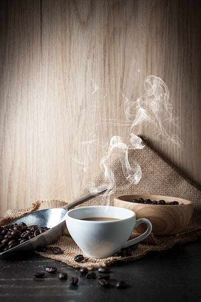 istock Coffee cup with coffee bean on black stone background 615603960