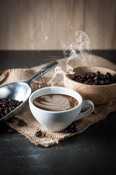 istock Coffee cup with coffee bean on black stone background 615604108