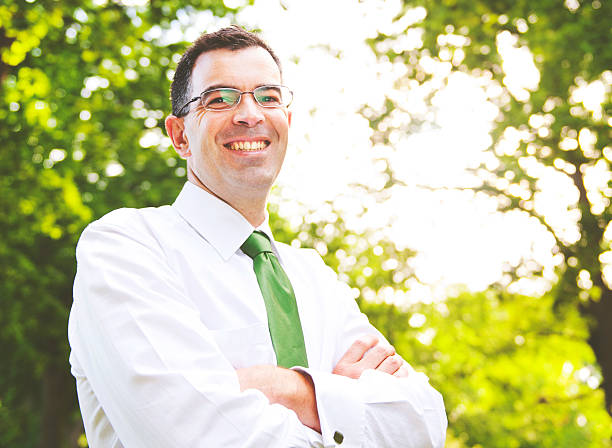Businessman Arms Crossed In A Forest Concept