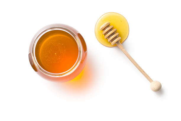 istock honey dipper and honey in jar 615605344