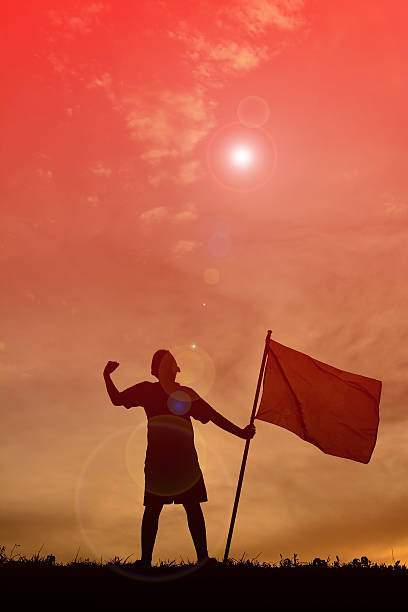 istock Silhouette boy holding flag at sunset. 615605960