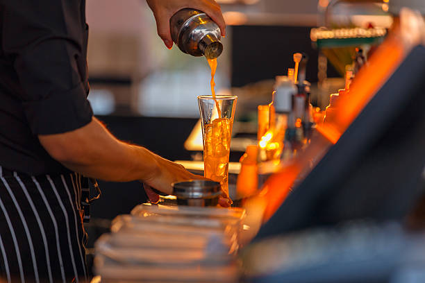 istock Process of preparing a cocktail bartender's from passion fruits 615608394