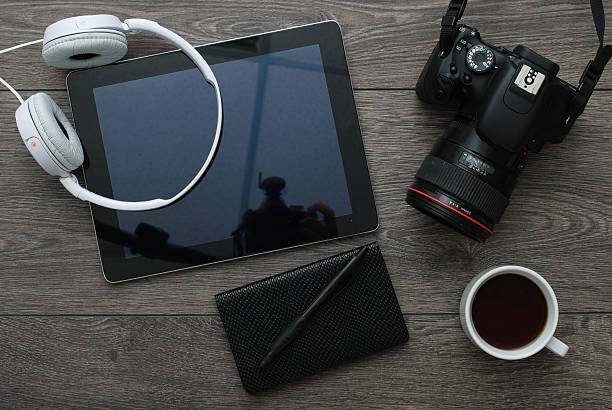 istock Office desk with Technology Equipment tablet, Camera and earphone 615608658