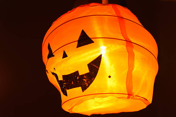 istock Halloween pumpkin head jack lantern with paper balloon 615609622