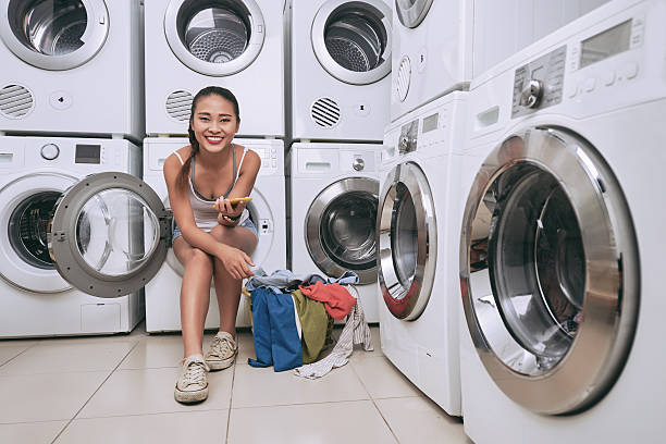 istock Female studentwashing clothes 615610434