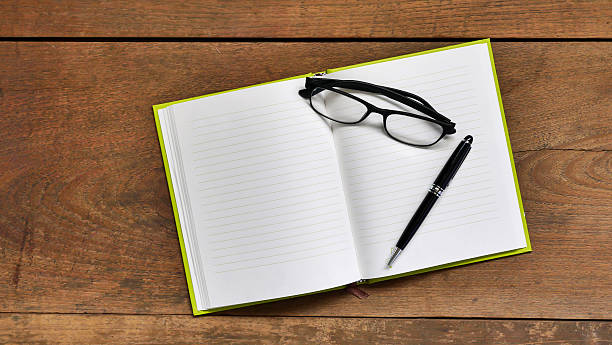 blank notebook with glasses and pen on wooden table - book photo album publication open imagens e fotografias de stock