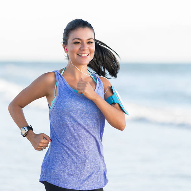 istock Fit woman exercises on the beach 615610786