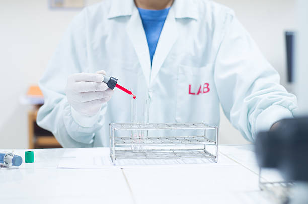 istock scientist with equipment and science experiments ,Laboratory gla 615611494