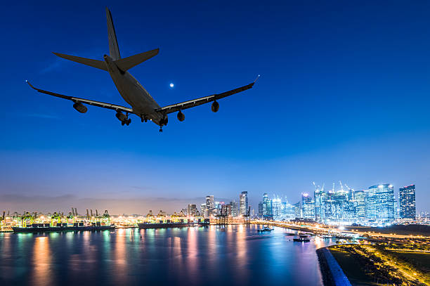 istock airplane landing in a night city 615613936