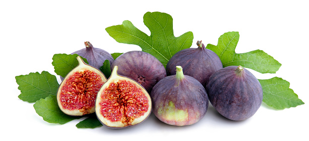 Fresh figs with green leaves on white background.Concept of healthy eating.