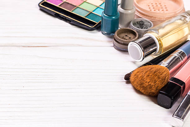 istock Various makeup products on wooden background with copyspace 615619642