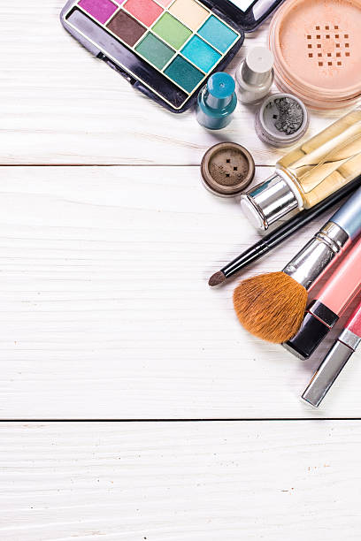 istock Various makeup products on wooden background with copyspace 615619718