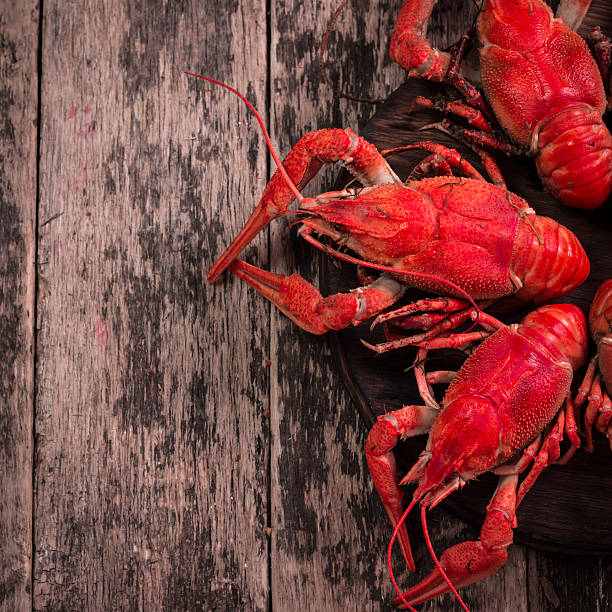 istock fresh boiled crawfish on the old wooden background 615622798
