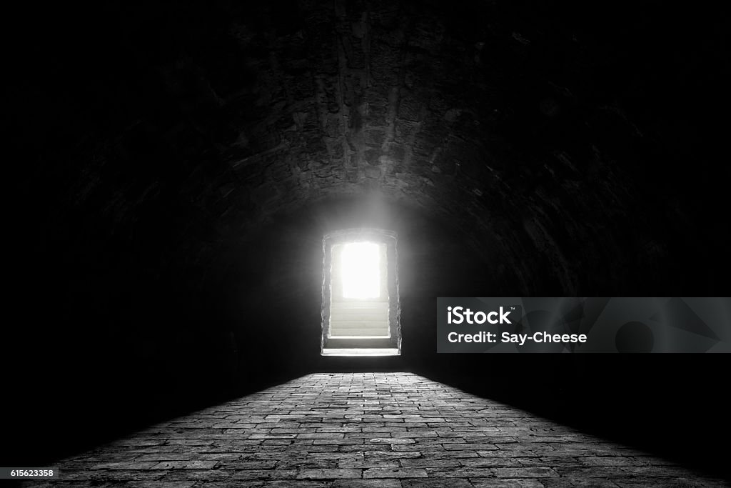 German medieval basement Interior image with a medieval german wine cellar, with its stone floor and the sunlight at the entrance Film Noir Style Stock Photo