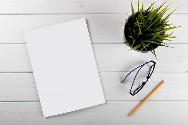 mockup with blank magazine cover on white wooden table