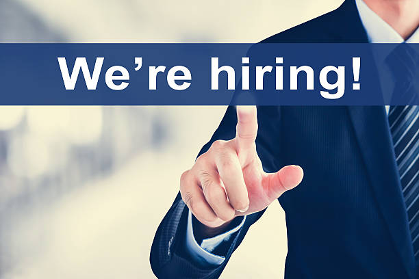 istock Businessman hand touching We're hiring! message on virtual scree 615624324