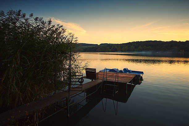 istock Pier and boat lake sunset 615626738