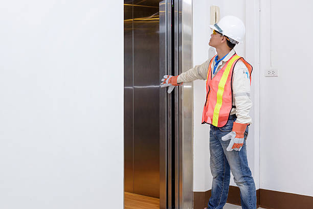 Technician - Engineer investigate work adjustment mechanism lift Technician - Engineer investigate work adjustment mechanism lifts the elevator. lift stock pictures, royalty-free photos & images