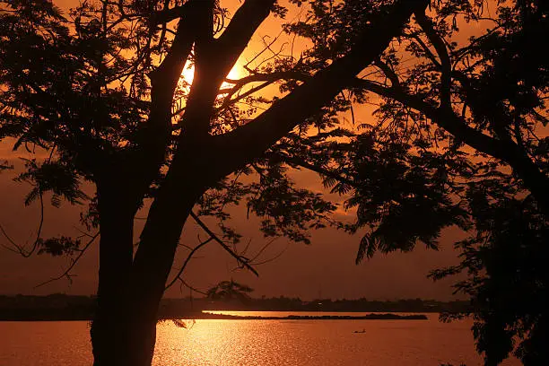 a sunset at the Mekong river in the town of Savannakhet in central Lao in the region of Khammuan in Lao in Souteastasia.