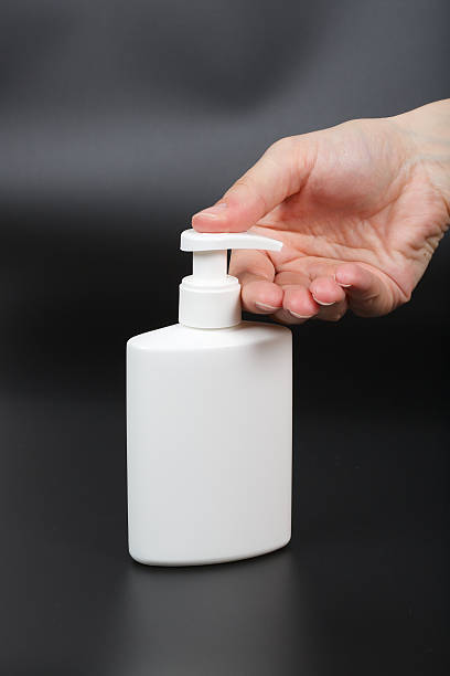 istock Liquid soap dispenser and a human hand 615630124