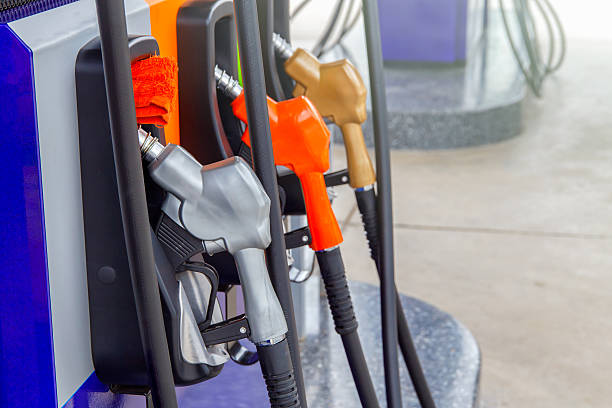 istock Gas pump nozzles in a service station 615631460