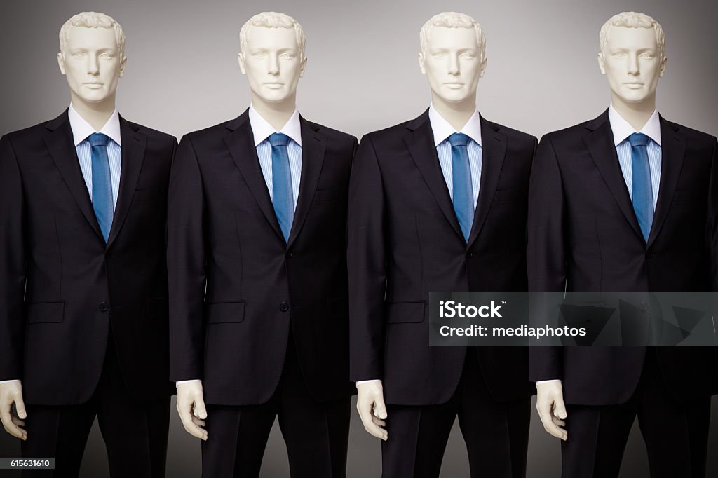 Business mannequin Image of mannequins in black suit standing in a row Mannequin Stock Photo