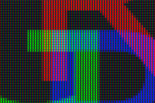 Close-up of a computer screen showing a pattern of red, green and blue LEDs together forming the letters RGB