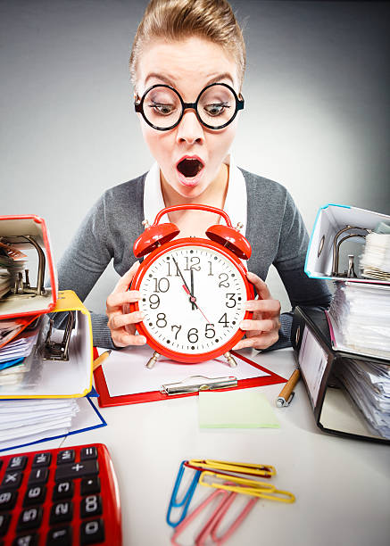 istock Businesswoman in office with big red clock. 615633010