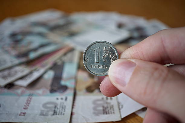 istock Male hand holding a Russian coin (Russian Ruble, RUB) 615634856