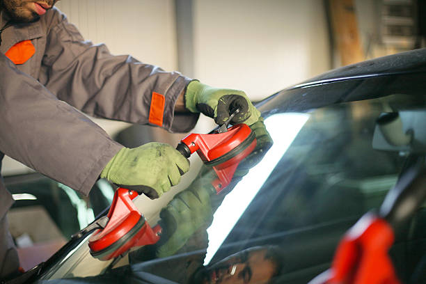 istock Mechanic changing glass on car. 615636536