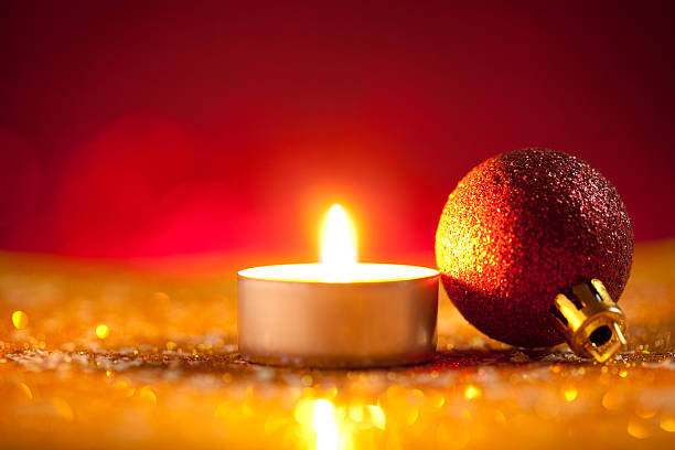istock Candle and bauble on glitter with red background 615637114
