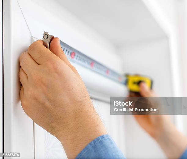 Man Installing Cassette Roller Blinds On Windows Stock Photo - Download Image Now - Measuring, Window, Instrument of Measurement