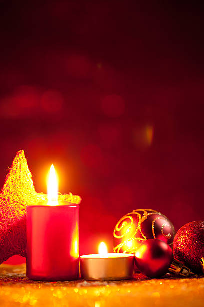 istock Candles and baubles on glitter with red background 615637424