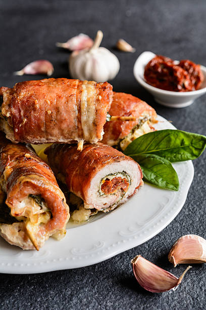 istock Pork cutlets wrapped in bacon, stuffed with cheese and spinach 615640930