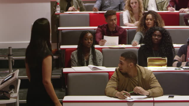 Female teacher talking with students in a lecture theatre, shot on R3D