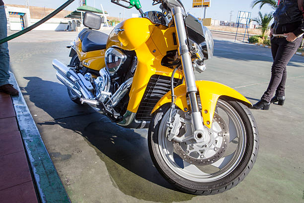 This is a photograph of a rough and tough biker riding a customized long handle barred hand crafted motorcycle that he built out in the desert east of San Diego out in Borrego Springs California. There is motion blur as he is speeding down the open road.