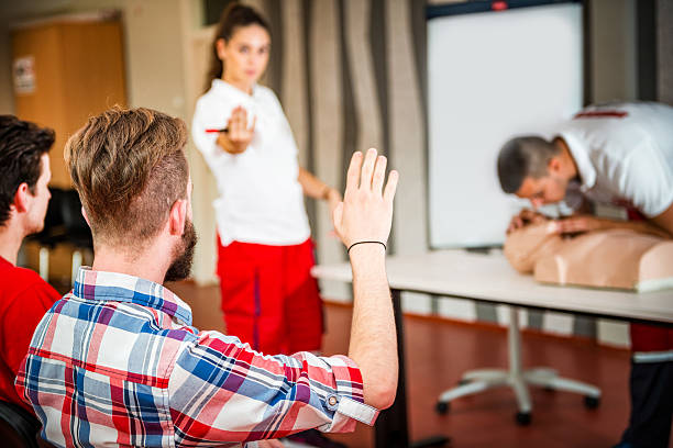 CPR training course CPR training course. Instructor interacting with students rescue services occupation stock pictures, royalty-free photos & images