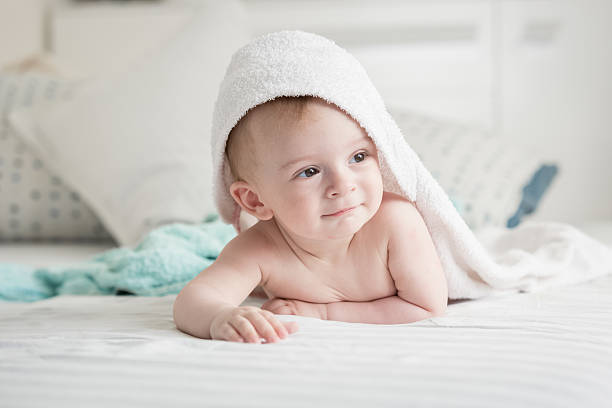 istock Happy baby looking under towel after having bath 615706812