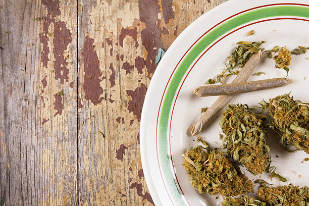 istock Marijuana buds and joints in the white plate 615708458