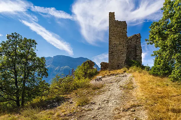 Ruins of Saint-Firmin castle (14th century medieval construction) at the entrance of Valgaudemar valley in the Hautes-Alpes. Summer in the Southern French Alps. France