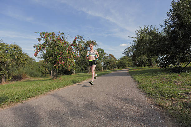 istock Fit athletic girl running 615712856