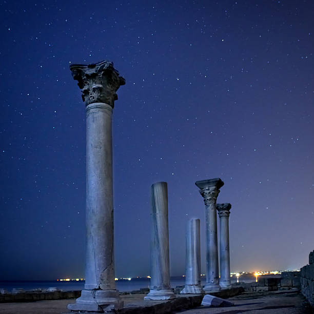 istock Ruins of ancient city columns under night sky 615714918