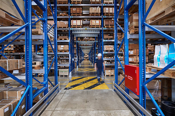 istock Coworker walking in warehouse aisle. 615715750