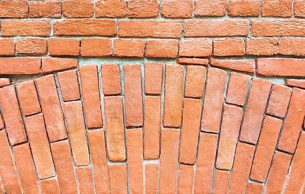 istock Fragment of a red brick wall with an arch. 615715972