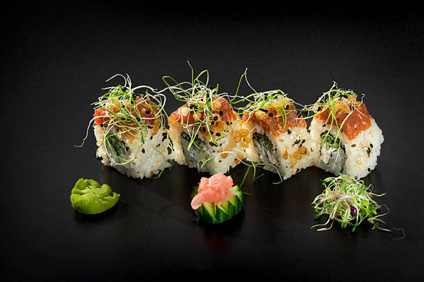istock Fresh Uramaki maki Sushi rolls over black background 615719118